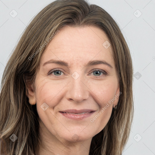 Joyful white adult female with long  brown hair and grey eyes