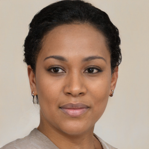 Joyful latino young-adult female with short  black hair and brown eyes