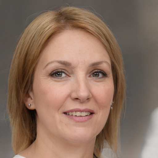 Joyful white adult female with medium  brown hair and grey eyes