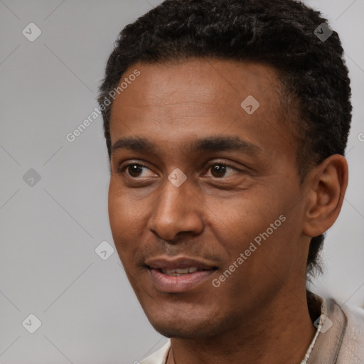 Joyful latino young-adult male with short  black hair and brown eyes