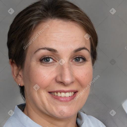 Joyful white adult female with medium  brown hair and brown eyes