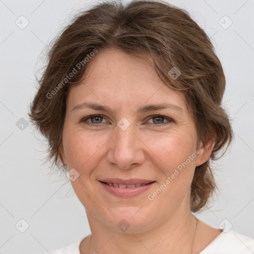 Joyful white adult female with medium  brown hair and green eyes