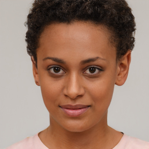 Joyful black young-adult female with short  brown hair and brown eyes
