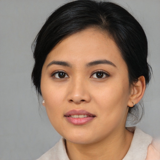 Joyful asian young-adult female with medium  black hair and brown eyes