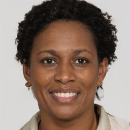 Joyful black adult female with short  brown hair and brown eyes