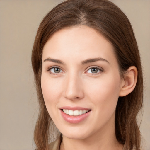 Joyful white young-adult female with long  brown hair and grey eyes