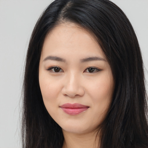 Joyful latino young-adult female with long  black hair and brown eyes