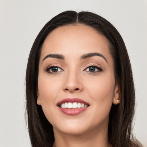 Joyful white young-adult female with long  black hair and brown eyes