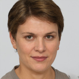 Joyful white adult female with short  brown hair and grey eyes