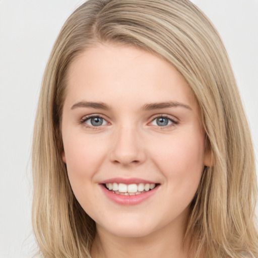 Joyful white young-adult female with long  brown hair and green eyes