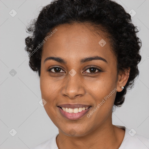 Joyful black young-adult female with short  black hair and brown eyes