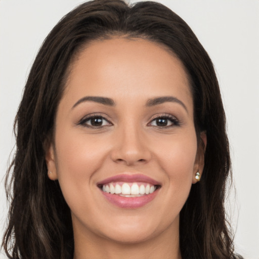 Joyful white young-adult female with long  brown hair and brown eyes