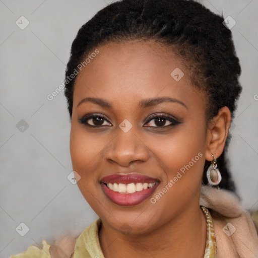 Joyful black young-adult female with long  brown hair and brown eyes