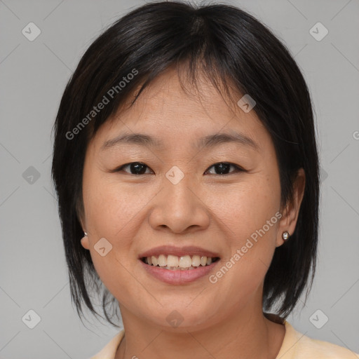 Joyful asian young-adult female with medium  brown hair and brown eyes