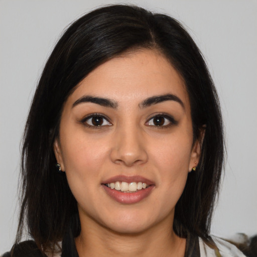 Joyful white young-adult female with medium  black hair and brown eyes