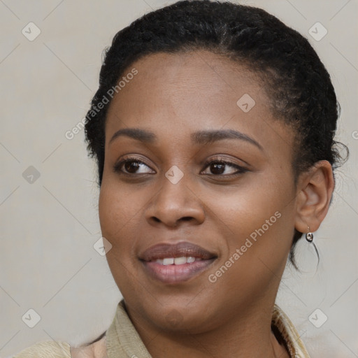 Joyful black young-adult female with long  brown hair and brown eyes