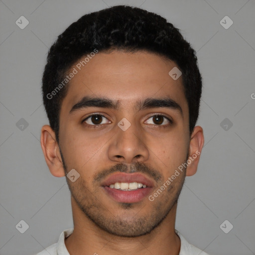 Joyful latino young-adult male with short  brown hair and brown eyes