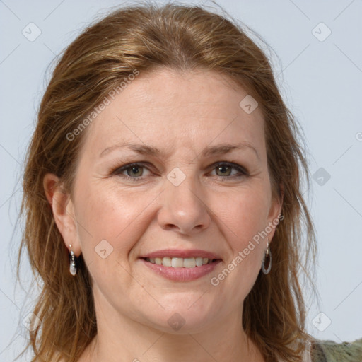 Joyful white adult female with long  brown hair and grey eyes