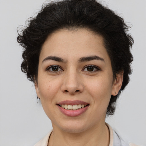 Joyful latino young-adult female with medium  brown hair and brown eyes