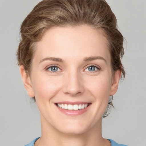 Joyful white young-adult female with medium  brown hair and blue eyes