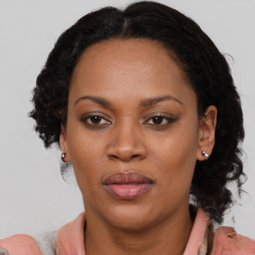 Joyful black adult female with medium  black hair and brown eyes
