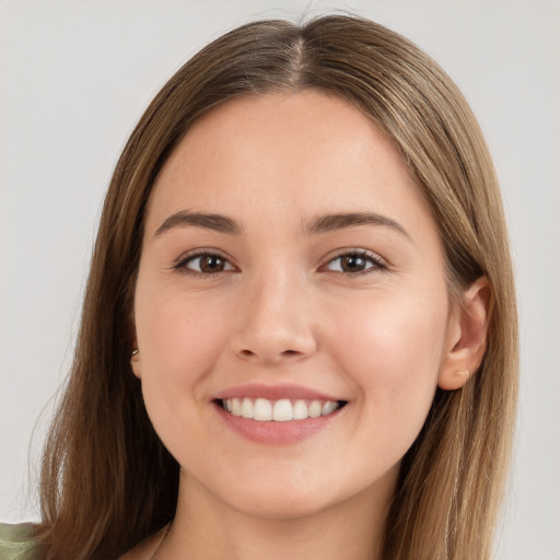 Joyful white young-adult female with long  brown hair and brown eyes