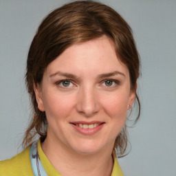 Joyful white young-adult female with medium  brown hair and blue eyes