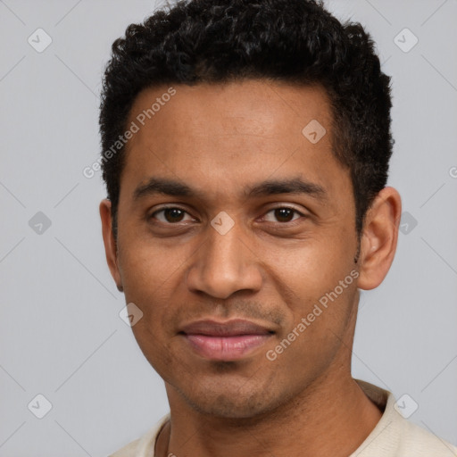 Joyful black young-adult male with short  black hair and brown eyes