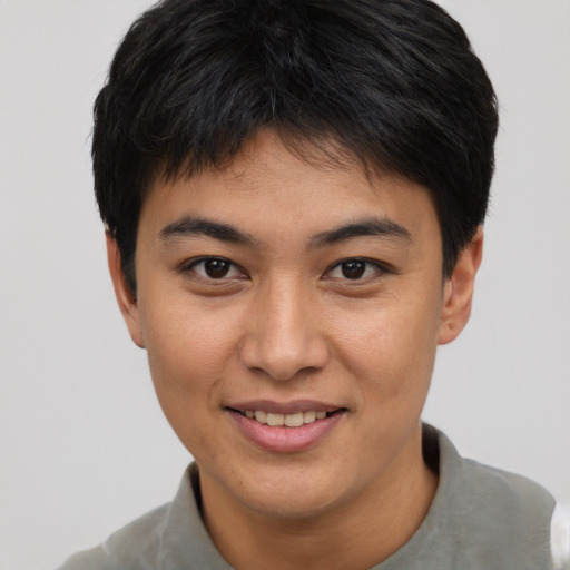 Joyful asian young-adult male with short  black hair and brown eyes