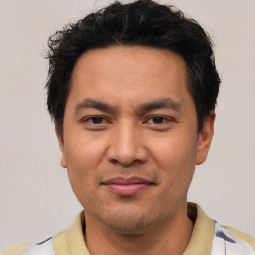 Joyful asian young-adult male with short  black hair and brown eyes