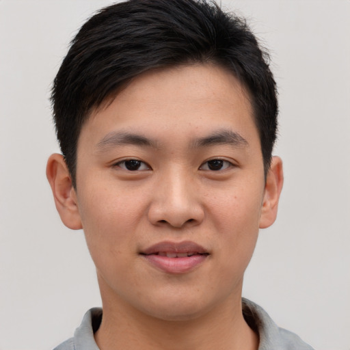 Joyful asian young-adult male with short  brown hair and brown eyes