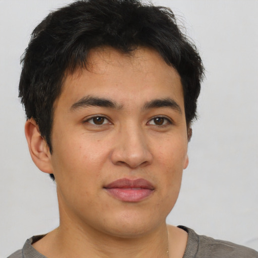 Joyful asian young-adult male with short  brown hair and brown eyes