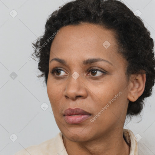 Joyful black adult female with short  brown hair and brown eyes