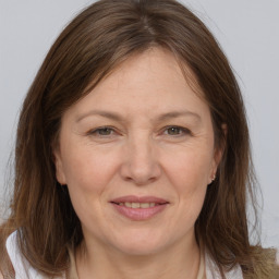 Joyful white adult female with medium  brown hair and brown eyes