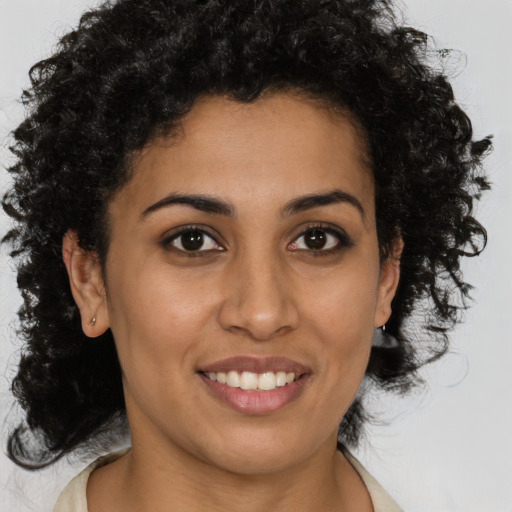 Joyful latino young-adult female with medium  brown hair and brown eyes