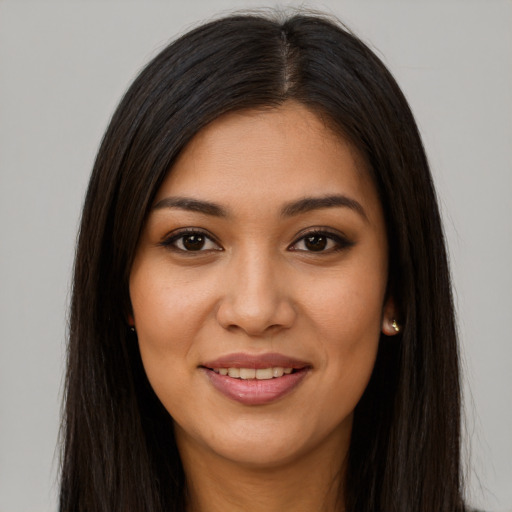 Joyful latino young-adult female with long  brown hair and brown eyes