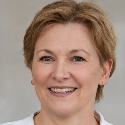 Joyful white adult female with medium  brown hair and brown eyes