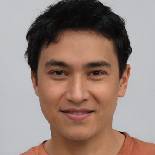 Joyful asian young-adult male with short  brown hair and brown eyes