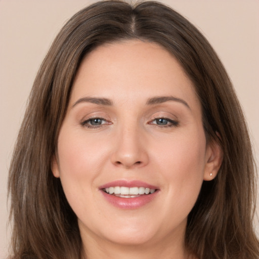 Joyful white young-adult female with long  brown hair and brown eyes