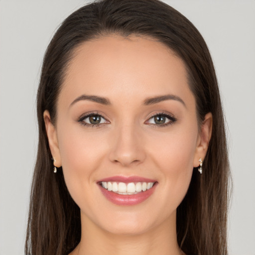 Joyful white young-adult female with long  brown hair and brown eyes