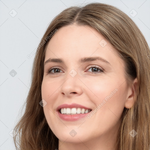 Joyful white young-adult female with long  brown hair and grey eyes