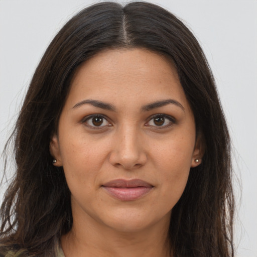 Joyful latino young-adult female with long  brown hair and brown eyes