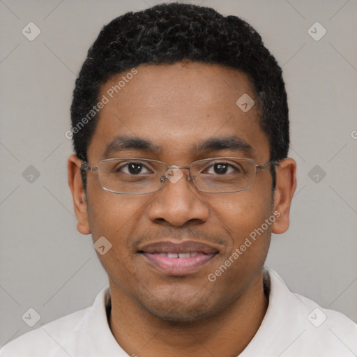 Joyful black young-adult male with short  black hair and brown eyes