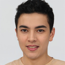 Joyful latino young-adult male with short  brown hair and brown eyes