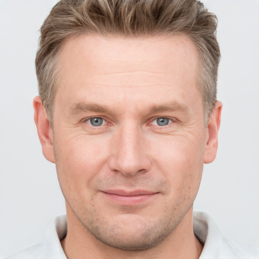 Joyful white adult male with short  brown hair and grey eyes