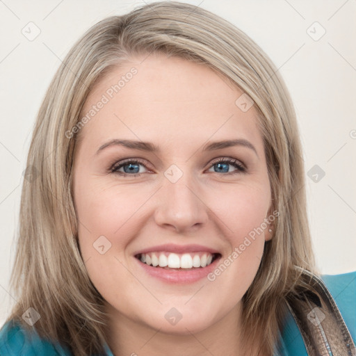 Joyful white young-adult female with long  brown hair and blue eyes