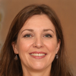 Joyful white adult female with long  brown hair and grey eyes