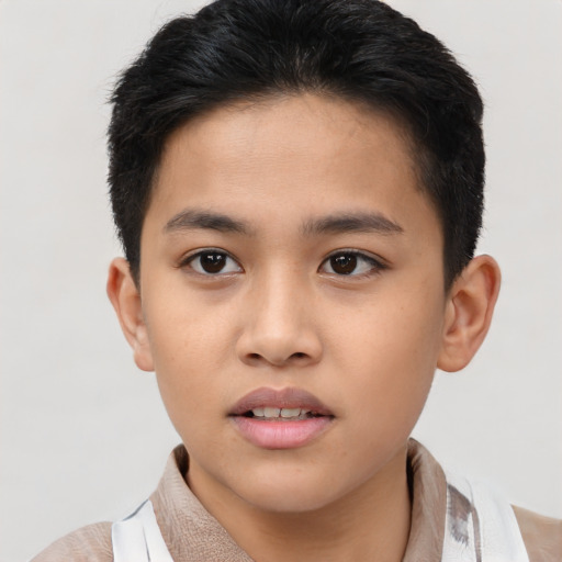 Joyful asian child male with short  brown hair and brown eyes
