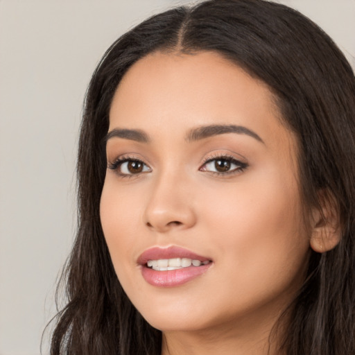 Joyful white young-adult female with long  black hair and brown eyes