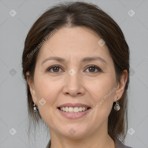 Joyful white adult female with medium  brown hair and brown eyes